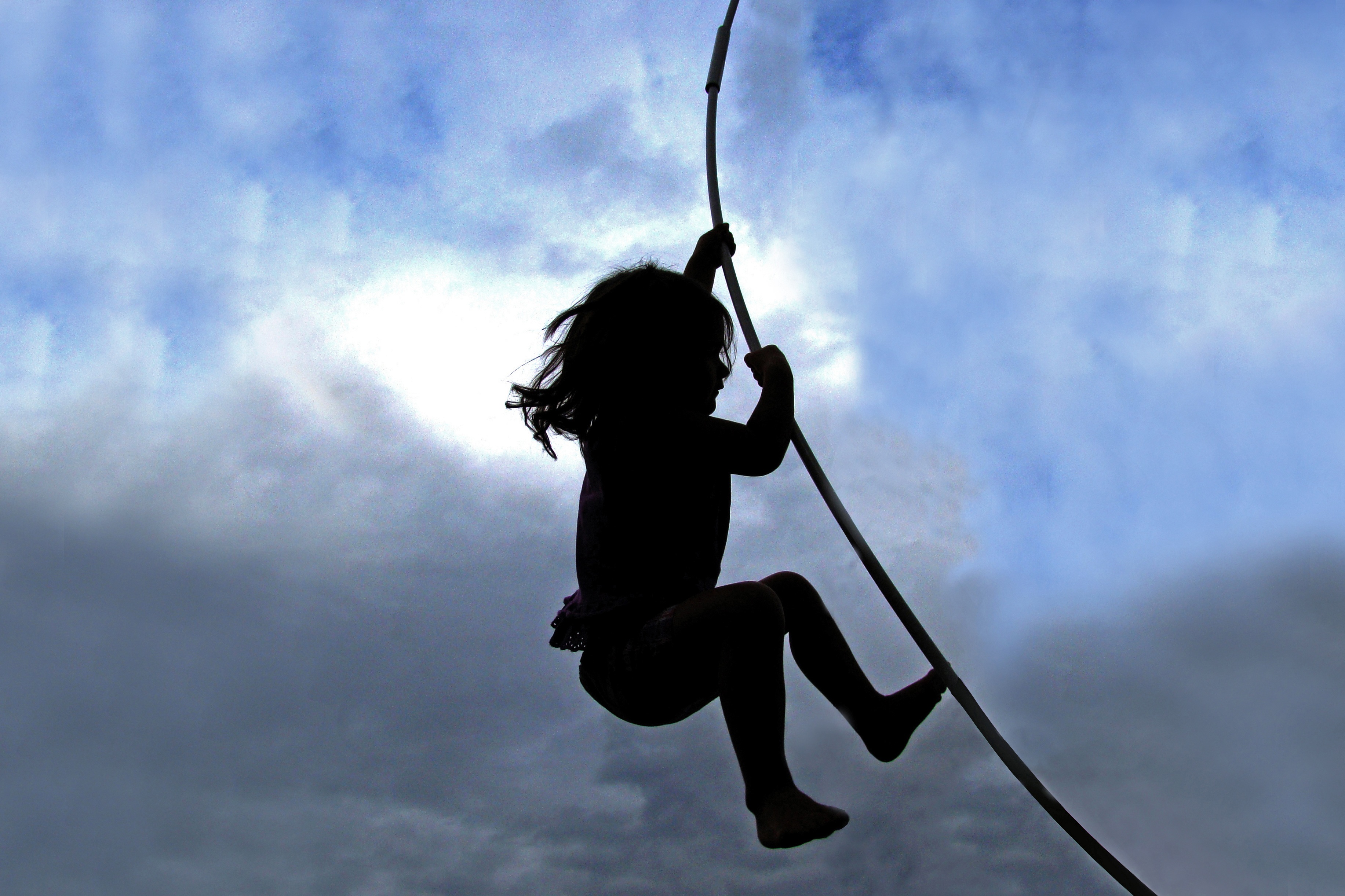 Little Girl Swings on a Rope